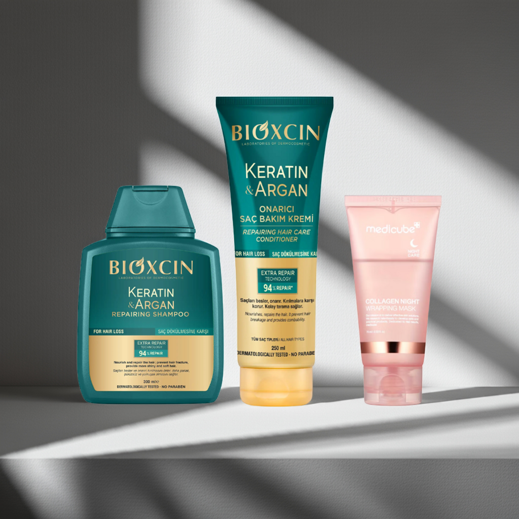 Bioxcin Keratin and Argan Repairing Shampoo and Conditioner and Medicube Collagen Night Wrapping Mask on a grey background
