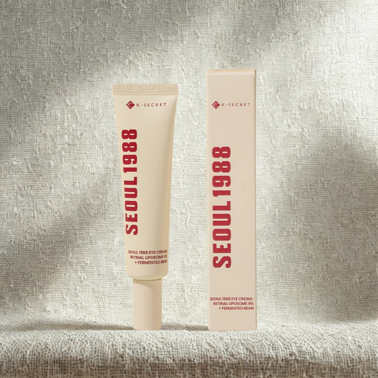 K-SECRET SEOUL 1988 eye cream tube and packaging on a textured gray background
