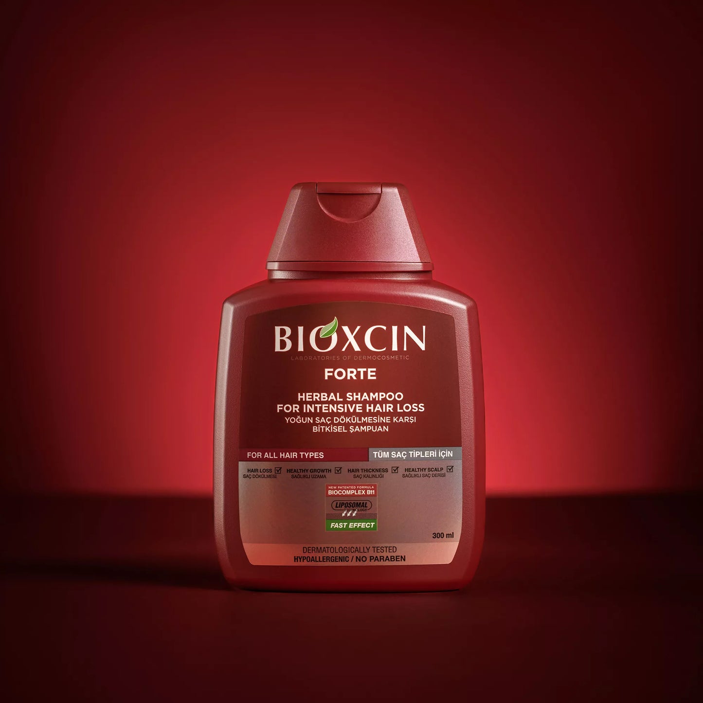 Bioxcin Forte shampoo bottle on a red background