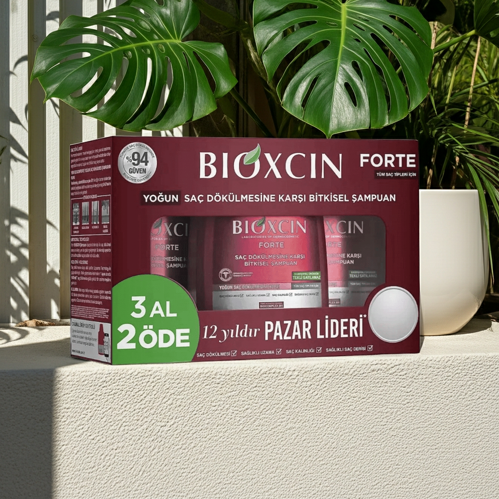 Bioxcin Forte hair care product packaging with green leaves in the background