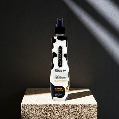 Bottle of Morfose Milk Therapy conditioner on a textured surface with a dark background