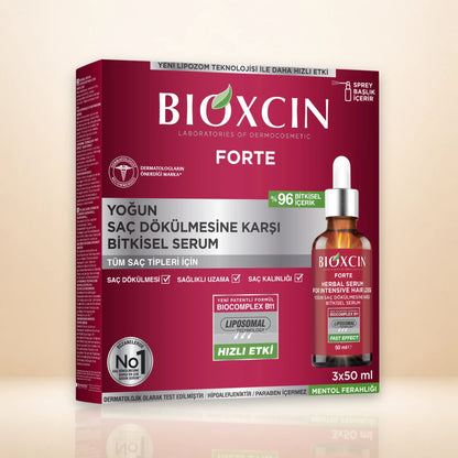 BIOXCIN FORTE hair serum packaging box shown alongside a small bottle of the serum on a clean beige studio background. The box is deep magenta with white and silver text, and the bottle is amber glass with a white dropper cap.