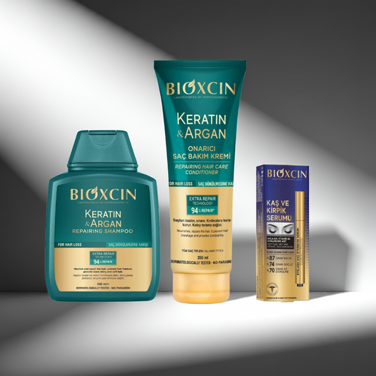 Bioxcin Keratin Argan Repairing Shampoo, Conditioner & Eyebrow and Eyelash serum on a grey background
