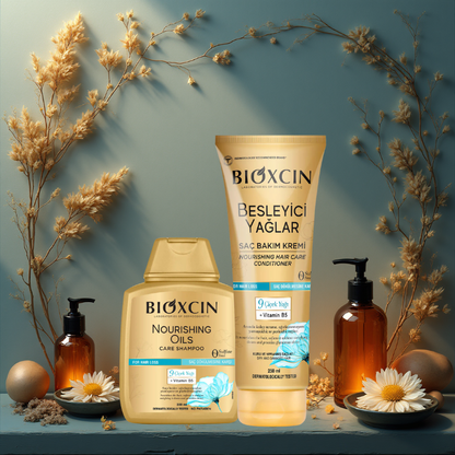 Bioxcin hair care products with shampoo, conditioner, and oil on a decorative background with flowers.