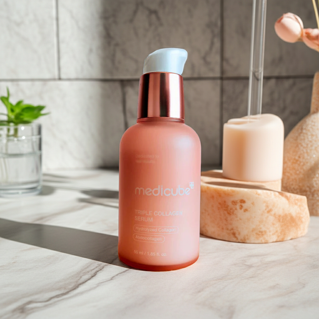 MediCube triple collagen serum skincare bottle on a marble surface with a blurred background