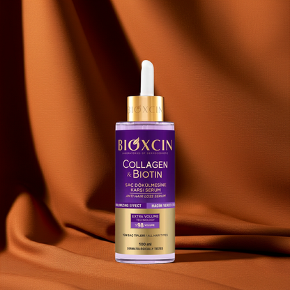 Bioxcin Collagen & Biotin serum bottle on an orange fabric background