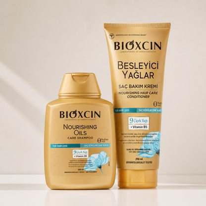 BIOXcin hair care products shown in a clean studio setup: a gold bottle of Nourishing Oils Care Shampoo and a gold tube of Besleyici Yaıklar Nourishing Hair Care Conditioner, both with blue and white label accents, on a light beige background.