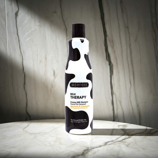 Morfose Milk Therapy shampoo bottle on a marble surface